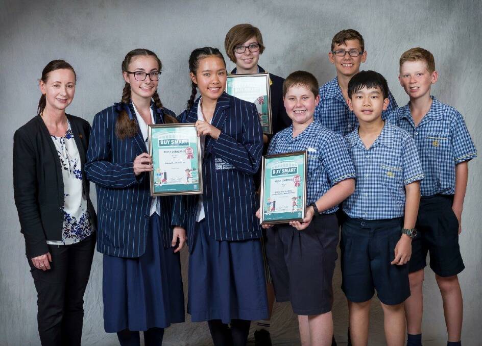 SMART CONSUMERS: Attorney General Yvette D'ath, Sheldon College students Madelize Breet and Alison Wu, Redlands College student Amelia Wakefield and Faith Lutheran College students Nicholas Bray, Mitchell Burchard, Alex Wong and Jonathon Culley.