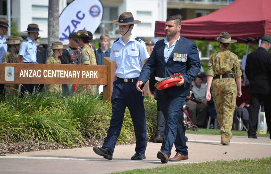 PROUD: Young Veterans Redlands representative Adrian Aiple (right) lays a wreath at the Cleveland Anzac service last Thursday.