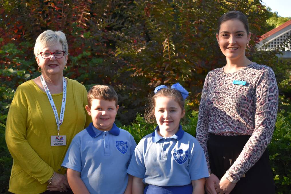 READY TO READ: Redland Bay State School's first Ready Reading volunteer Catherine Benham with Harry Connor, Tigerlily Foord, and school Ready Reading co-ordinator Caitlin McIlwain.