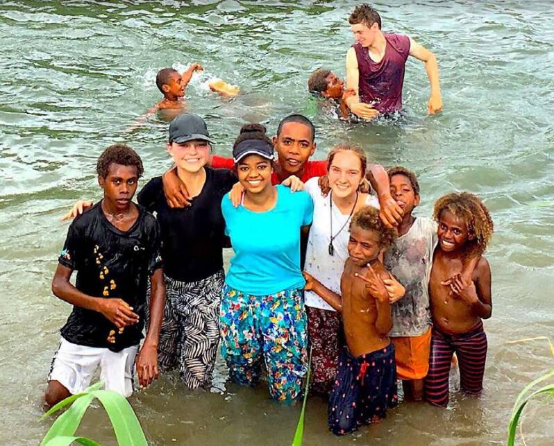 VILA: Redlands College students on past trips to Vanuatu with local children.