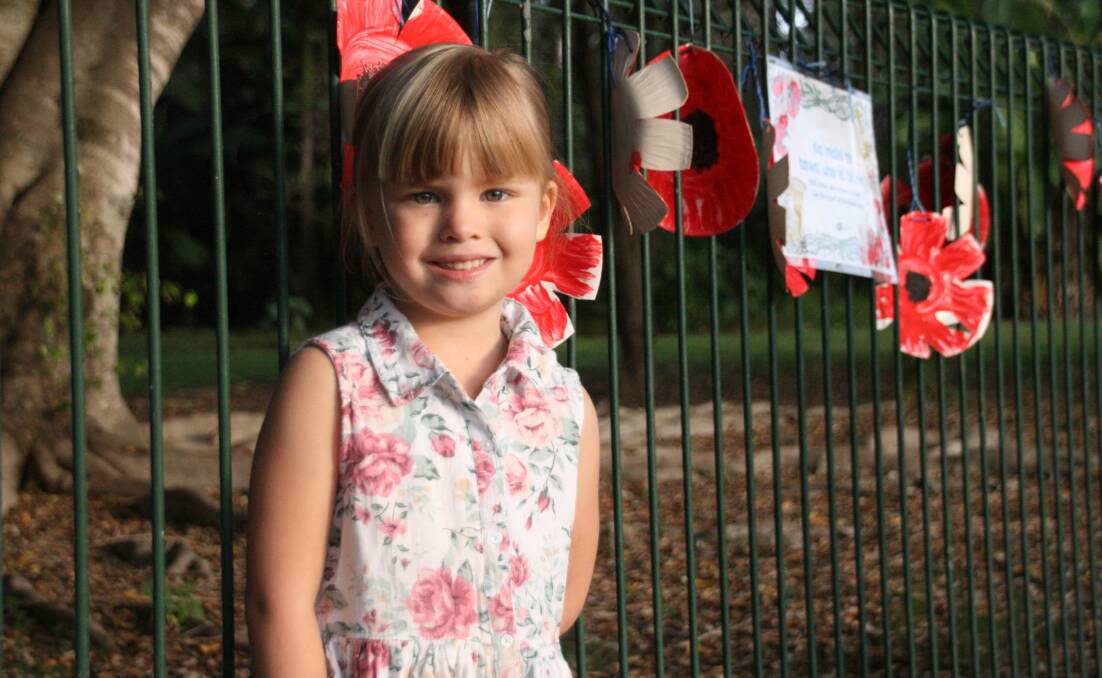 HOPE FENCE: Destiny, 5, painted poppies for Anzac Day.