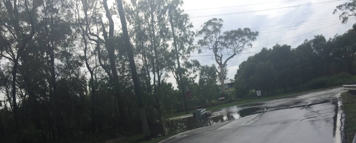 IF IT'S FLOODED, FORGET IT: Water was spilling over the road at Mount Cotton on Sunday morning.