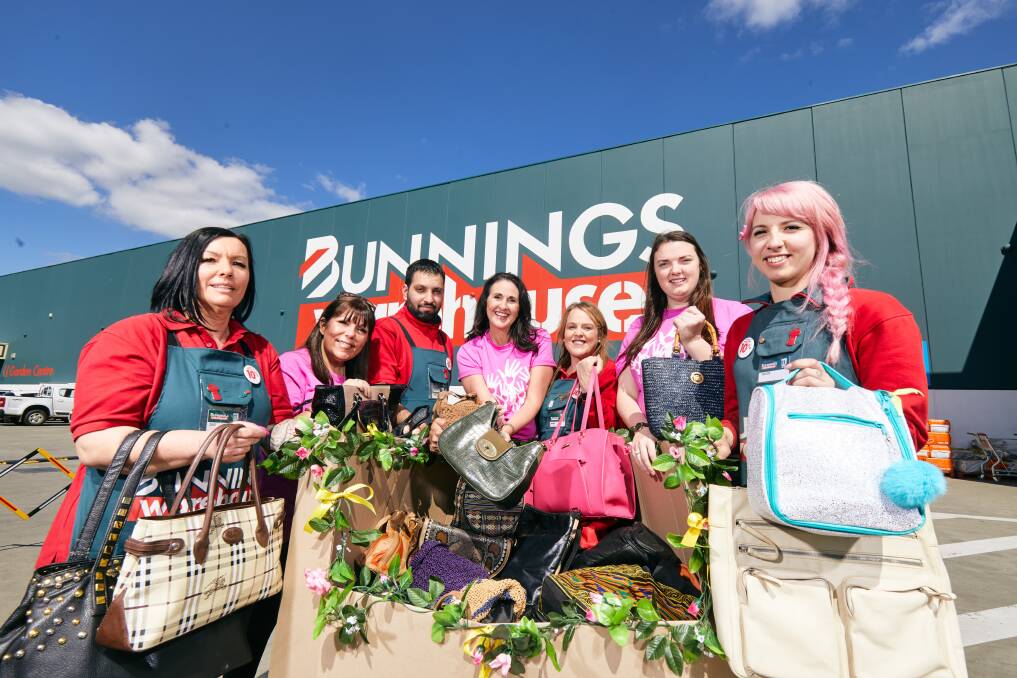SHARE THE DIGNITY: Bunnings employees collect bags of hygiene essentials.