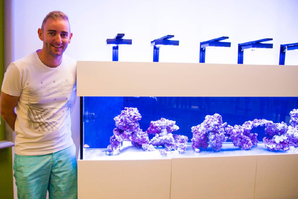 SCIENCE OF THE SEA: Marine science teacher Brad Lawrence with the school's new tank.