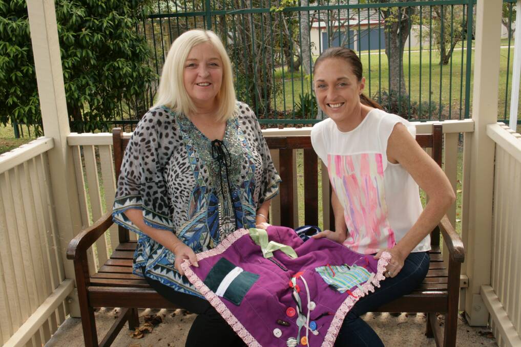 EASING THE SUFFERING: Kym Gardener and Shannon Windle with their mother Maureen's busy blanket at Blue Care Wirunya.