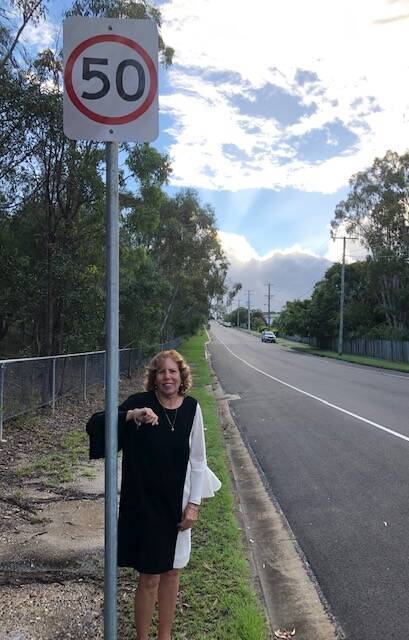 SPEED SIGN: Cr Tracey Huges with a new 50km/h speed sign on McMillan Road.