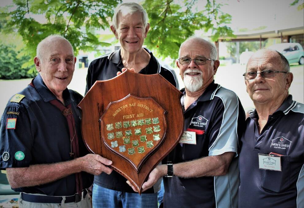 Men's Shed vice president Clive Shepherd, Les Saunders and Ben Grimes presenting the shield to Paul Suss.