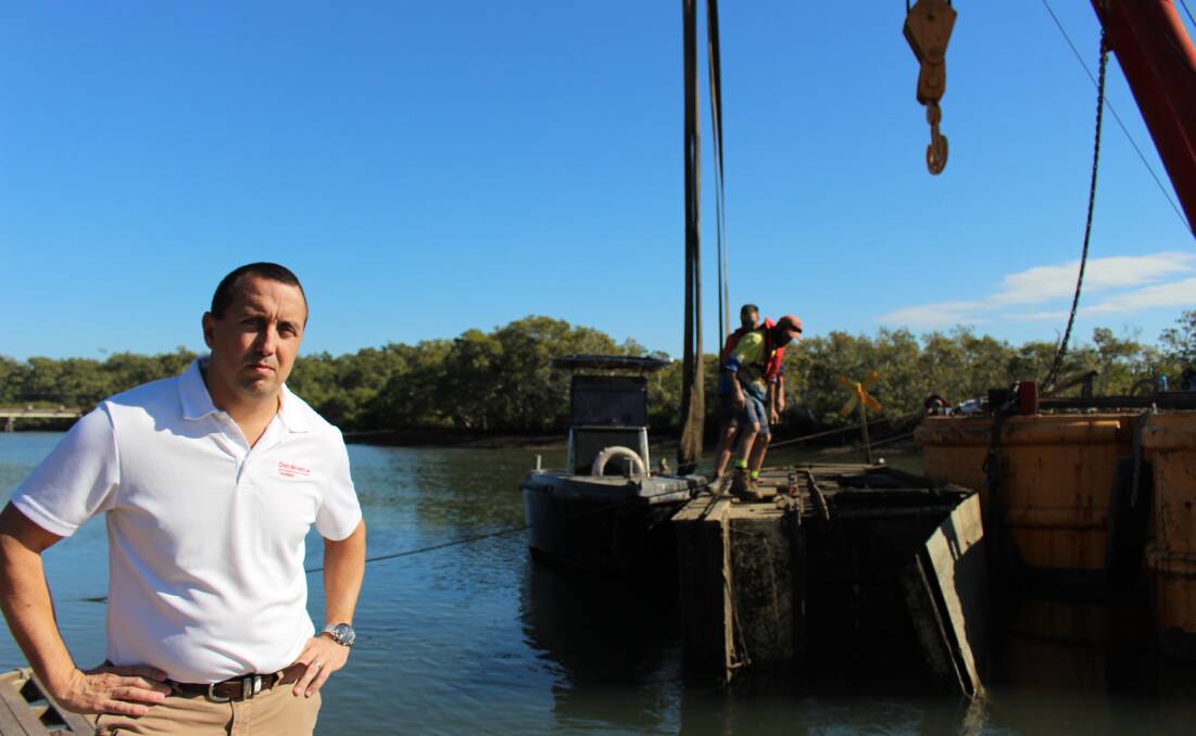 WRECKS: MP Don Brown at Tingalpa Creek where wrecks are being removed. People leaving damaged boats to rot in waterways to be removed at taxpayers cost are a big problem in the Moreton Bay region.