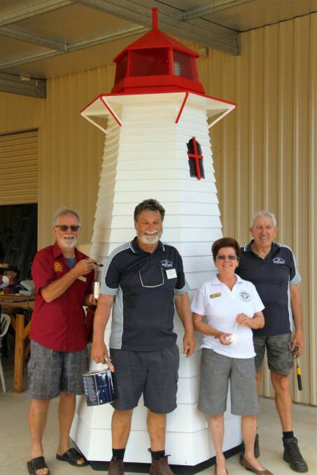 LIGHT IS ON: Phil Robinson of the Redlands Museum, Alfred Zapf of the CUC Men’s Shed, Wendy Ruwoldt of the CUC Christmas light convenor and Derek Manuel of CUC Men’s Shed and the lighthouse.