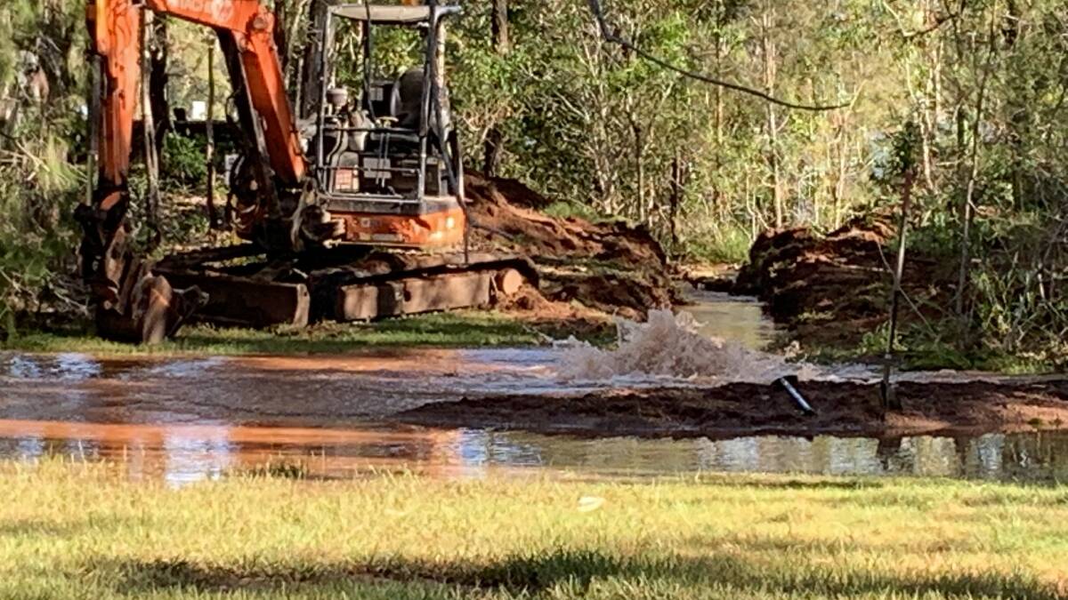 MAIN BURSTS: The scene at the broken water main on the island.