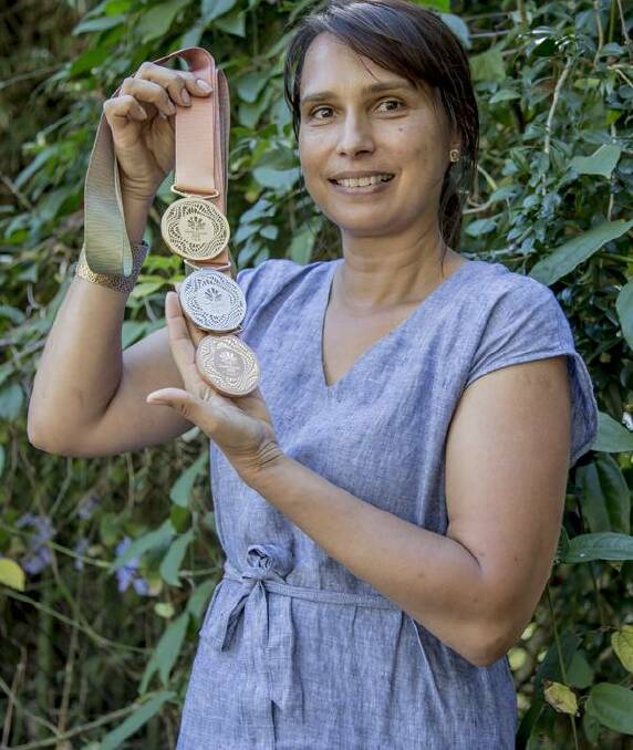 SHINING STAR: Delvene Cockatoo-Collins with the medals she designed for the Gold Coast Commonwealth Games.