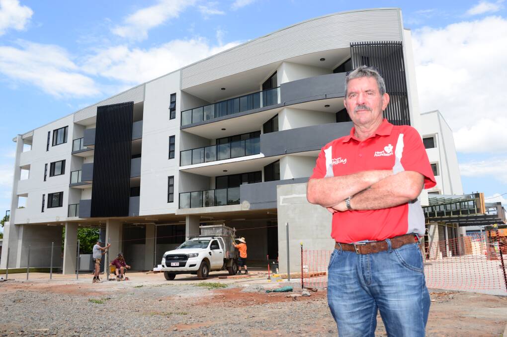 GROWTH TOO MUCH: Redland Bay resident Ron Ferrari in front of units being built near his home. He says too much growth has made traffic unmanageable and is ruining the suburb.