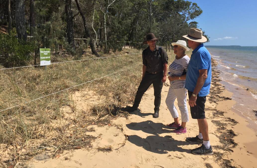 BEACH INSPECTION: Federal government Threatened Species Commissioner Gregory Andrews with islanders Vivenne and Graeme Roberts-Thompson.