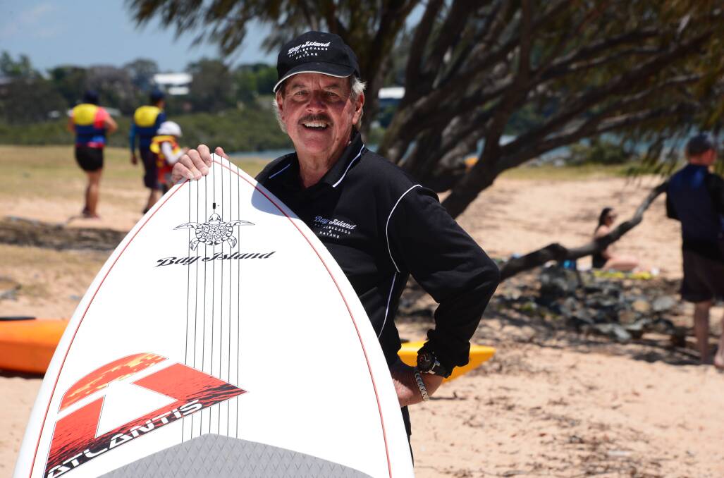 FOR HIRE: Lance Judd hires out stand-up paddle boards and other beach gear at Raby Bay, mostly on weekends.