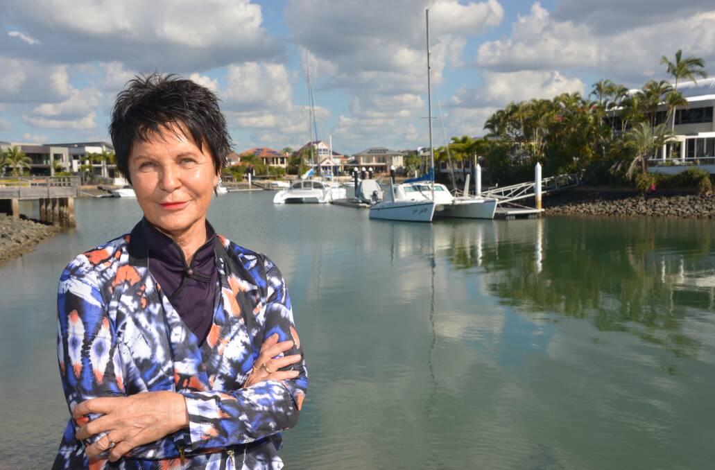 WALL WORRIES: Raby Bay resident Zrinka Johnston wants council to do more work in tackling reventment wall problems in the 21 kilometre canal estate. Photo: Brian Williams.