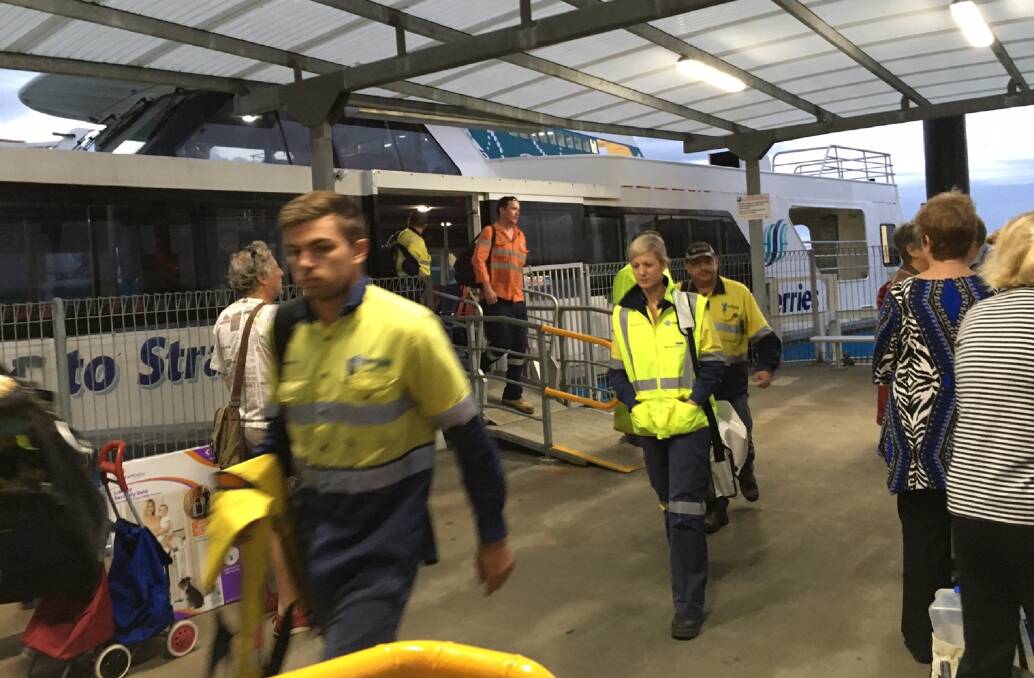 ISLAND CHANGES: Mine workers alight from a North Stradbroke Island ferry.