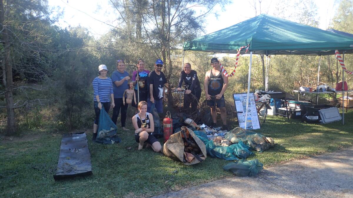 TOUGH MANGROVE MUDDERS: Some of the crew with some of the rubbish collected at Wellington Point.