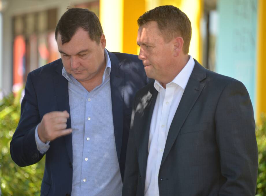 TOUGH TIMES: Matt McEachan on the campaign trail with opposition treasury spokesman Scott Emerson. Mr Emerson also appears set to lose his seat, possibly to the Greens.