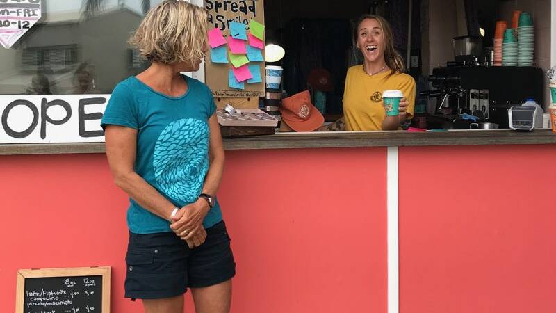 SMILES: Sue Jenner, the owner of Island Juice, a Straddie juice van, gets a coffee from Jess Scott of Starfish Studios, a Point Lookout homewares designer. Sue's shirt is a Starfish Studios design.
