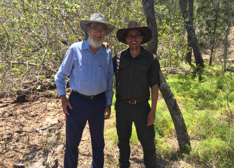 IN THE WETLANDS: Local Bruce Wollstein, who has been hand weeding at Coochiemudlo Island for 23 years, with Threatened Species Commissioner Gregory Andrews.