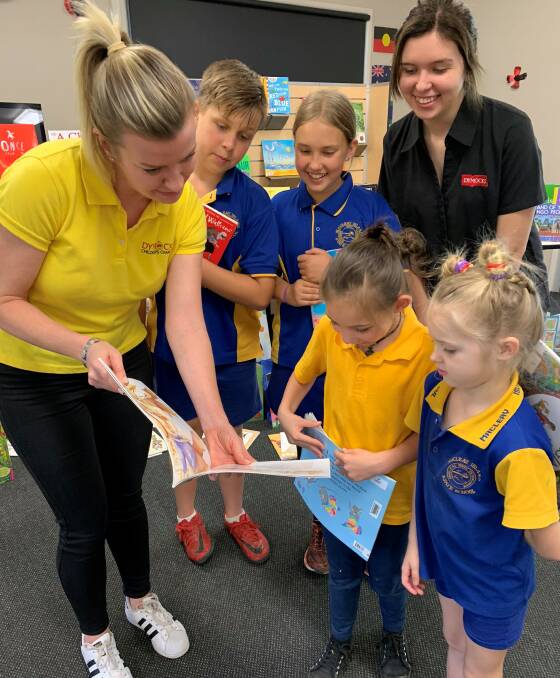 BOOK BONANZA: Dymocks Children's Charity general manager Terri Martin and Demi from Dymocks Carindale reading to Thomas Purdy, Livv Zastera, Hope Longland and Kaylee-Anne Travis.