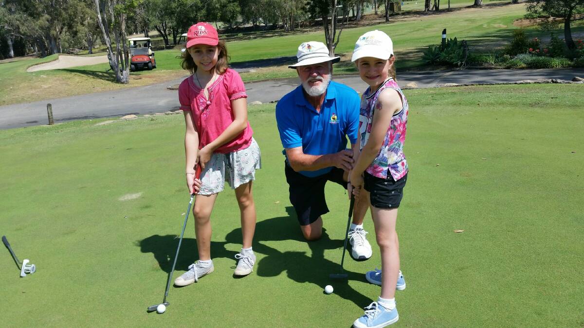 PUTTING PRACTICE: Redland Bay Golf Club member Bob Muir with granddaughters Julia and Veronica at putting practice as part of golf month.