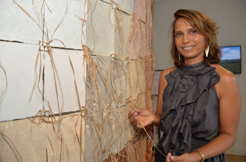 CREATIVE: Artist Delvene Cockatoo-Collins with one of her artworks on show at the Cleveland Art Gallery.