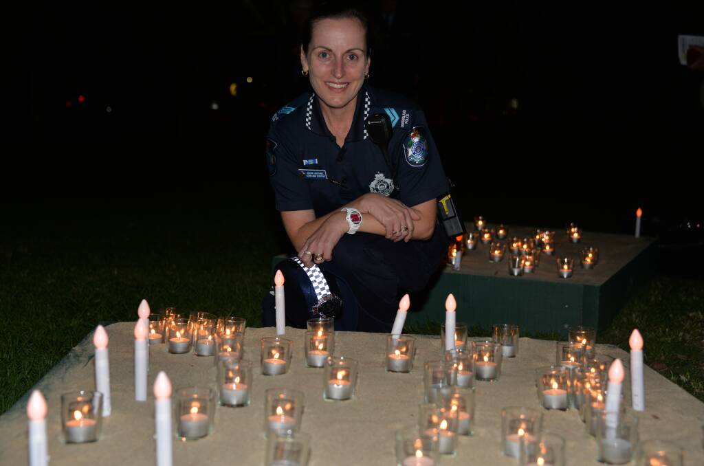 police in force: Sen Constable Kerri-Ann Stevens from the domestic, family violence and vulnerable persons unit takes part in the candle ceremony.