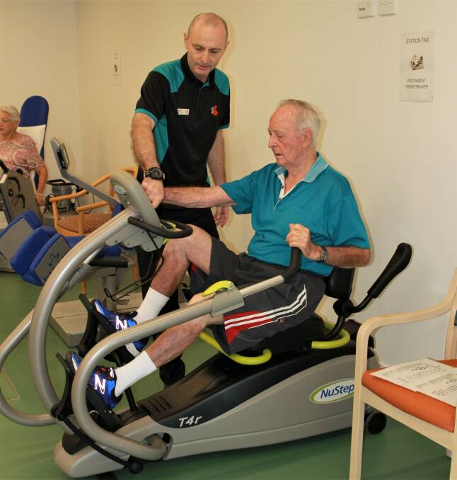 GO HARD: Moreton Shores physiotherapist Mark Aumuller supervises a fitness program for retirement living resident Graham Herdsfield.
