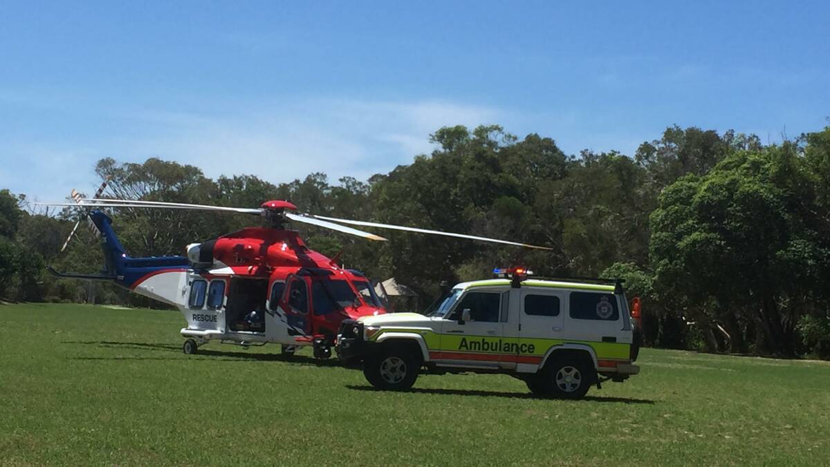 HELP ARRIVES: A rescue chopper and ambulance work together at another rescue on North Stradbroke Island.
