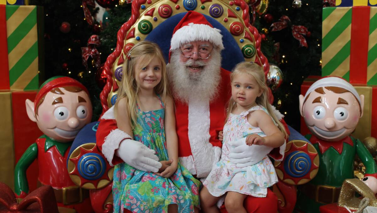 HELLO SANTA: Aria James, 4, and Emily James, 2, of Alexandra Hills with Santa Clause and his real beard.
