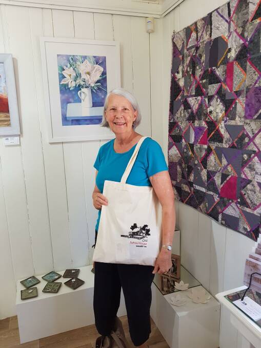 BIG SURPRISE: Sue Thomas a regular gallery visitor who won a gift bag.