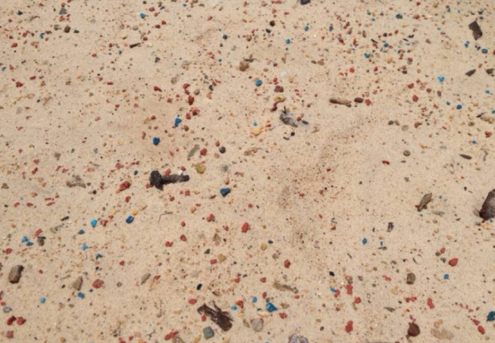 POLLUTION: The Manly plastic playground matting dispersed across the nearby beach.