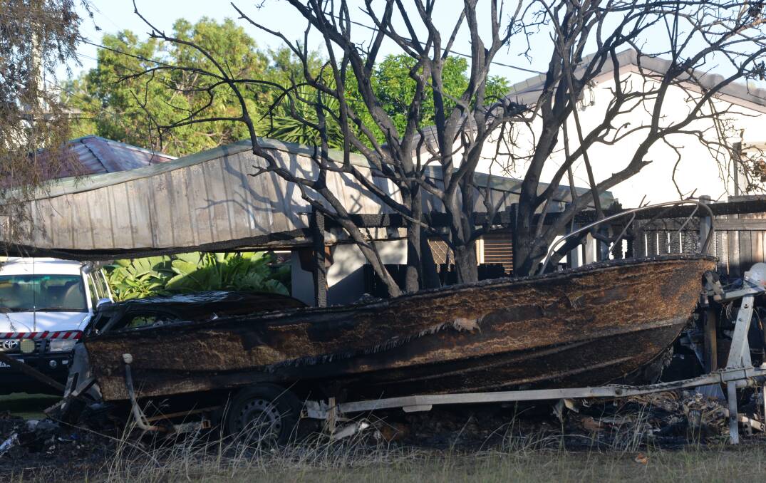 FIRE PROBE: The boat and carport destroyed in the early morning fire at Alexandra Hills.