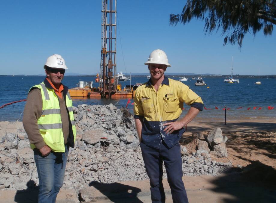 RAMP UP: Pensar Construction Group foreman Phil Mandall and site worker Rowland Gittoes supervise the demolition and removal of the old Coochie barge ramp.
