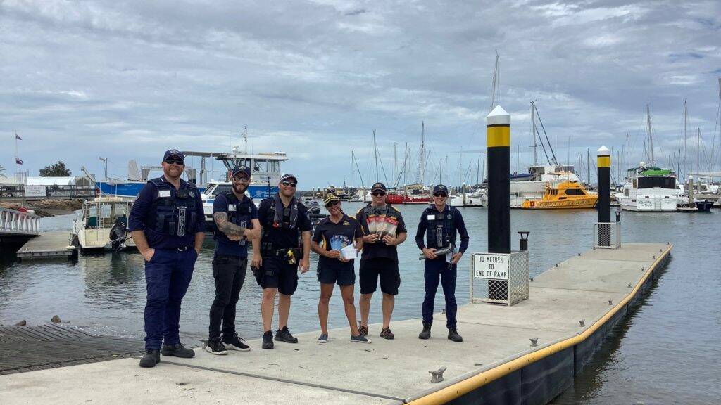 CHECK UP: The line-up of officers at Manly Harbour boat ramps last weekend where fishing and boat safety checks were conducted.