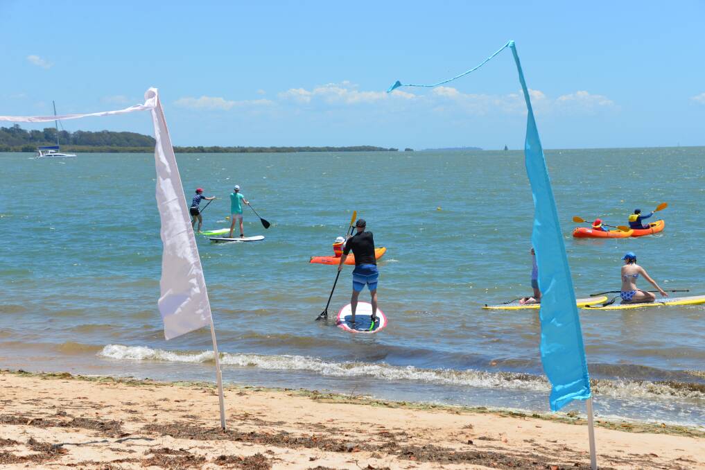 BUSY MORNING: Saturday at Raby Bay, with stand-up paddle boards and kayaks on the water.
