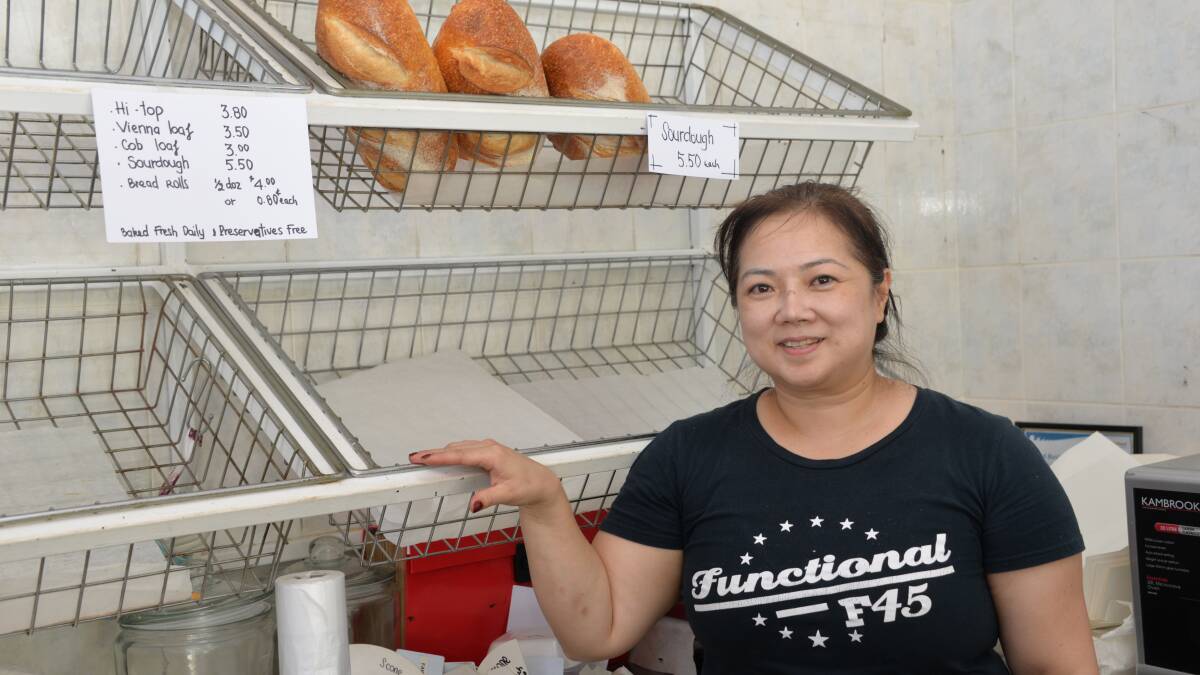 POPULAR LOAVES: Tina Truong with empty shelves before lunchtime. The Alexandra Hills bakery has doubled its output to meet demand.