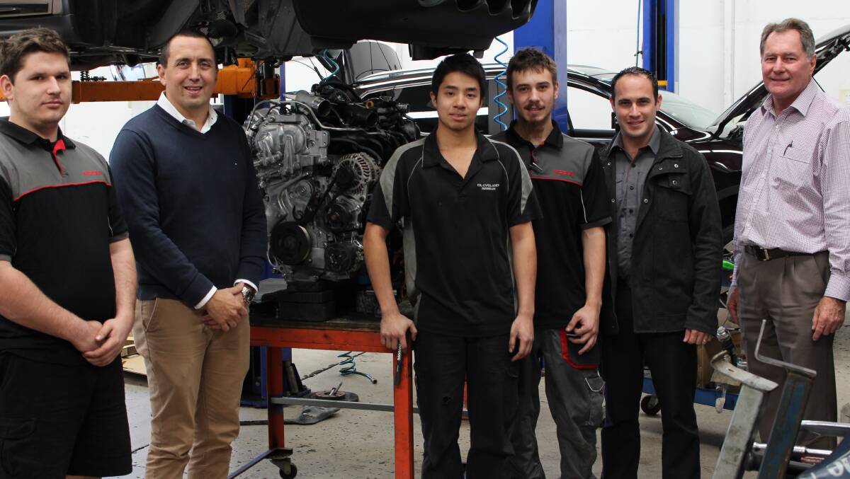 COLLEGE GRADS: MP Don Brown and Barry Evans with Cleveland Nissan apprentices.