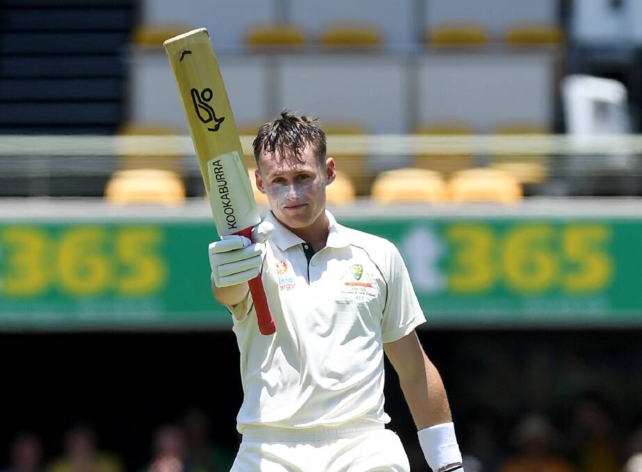 FAVOURITE SON: Labuschagne raises the bat after scoring a hundred at the Gabba against Pakistan. Photo: Cricket Australia/Getty Images