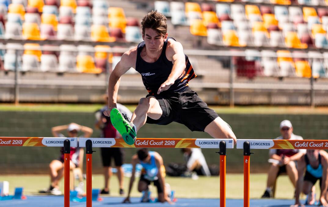 GAME FACE: Riley Higgins, a music student at Queensland University of Technology, has leapt his way into the best young hurdlers in Australia. Photo: Casey Sims