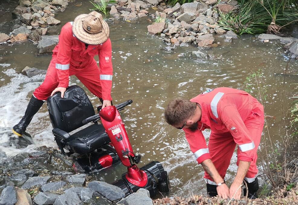 NO ROOM FOR WASTE: The Coastal Scavengers pull a mobility scooter out of a Capalaba creek. Photo: supplied
