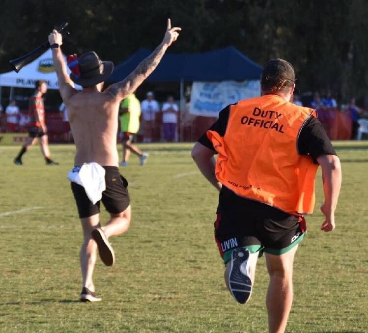 BIG TACKLE: Redlands Parrots president Todd Flahey ran down a pitch invader during Staurday's men's division one final at Thornlands. 