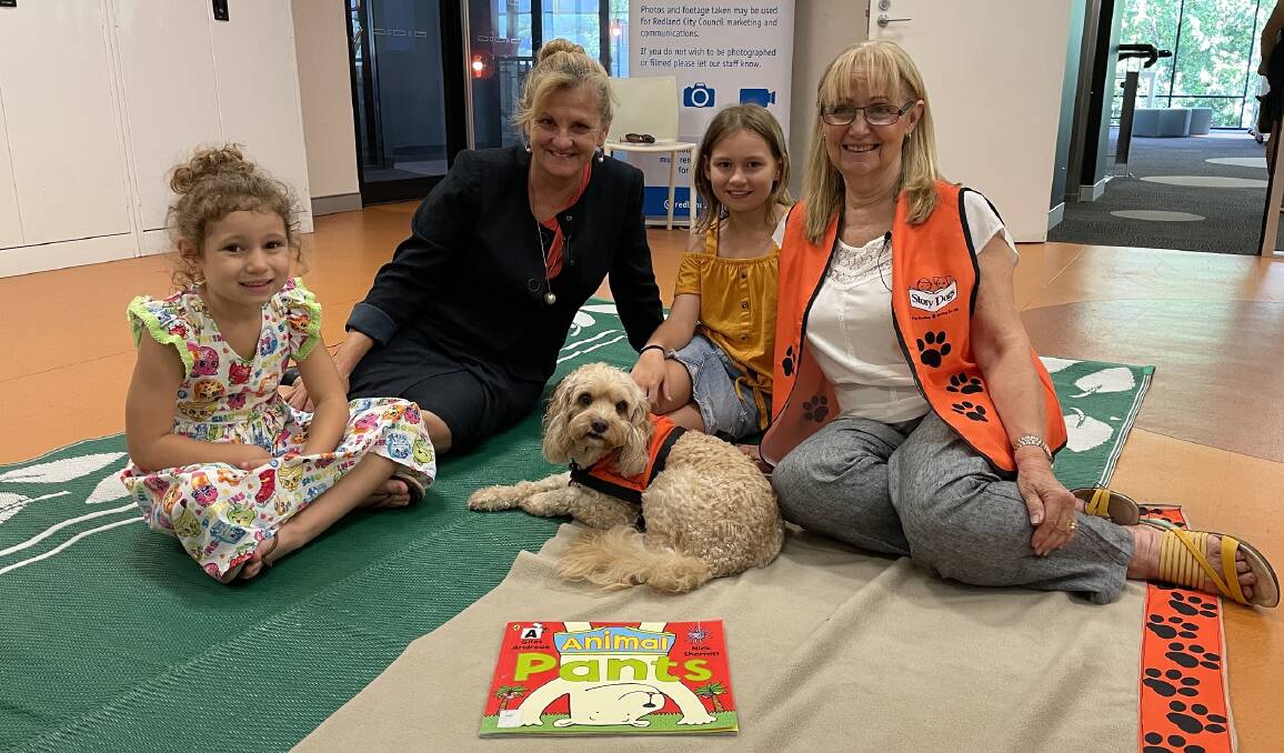 CLEVER POOCHES: Mayor Karen Williams, Story Dogs volunteer Jeanne Bonney with her Cavoodle Lottie, and sisters Abigail and Taylor at Victoria Point Library. 