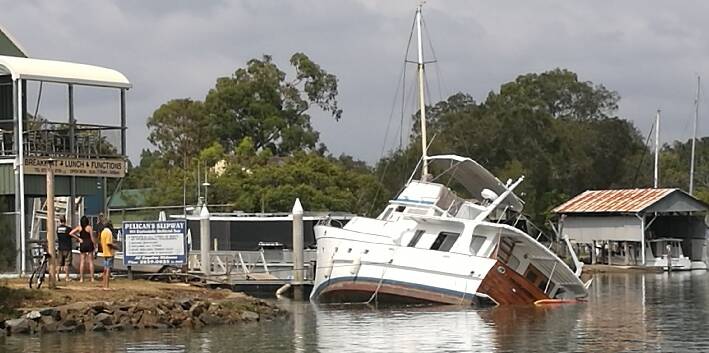 SINKING: The boat was tied to the structural supports of Pelican's View Cafe. Photo: Steven Komorowski