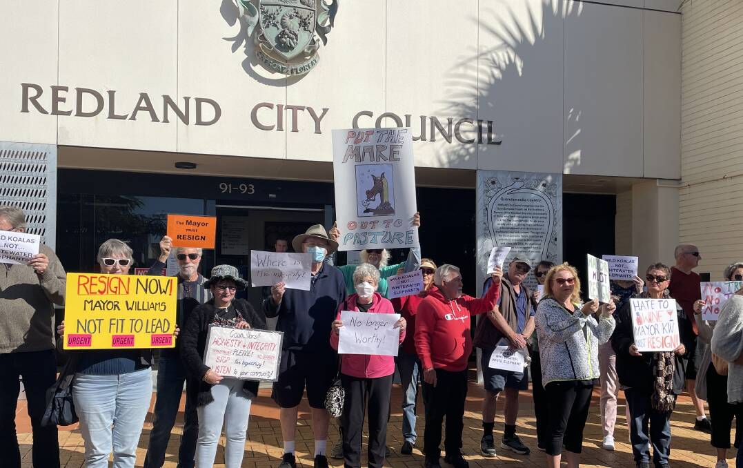A small crowd gathered outside the Redland City Council chambers on Wednesday to protest Mayor Karen Williams staying on in the role. Photo by Jordan Crick