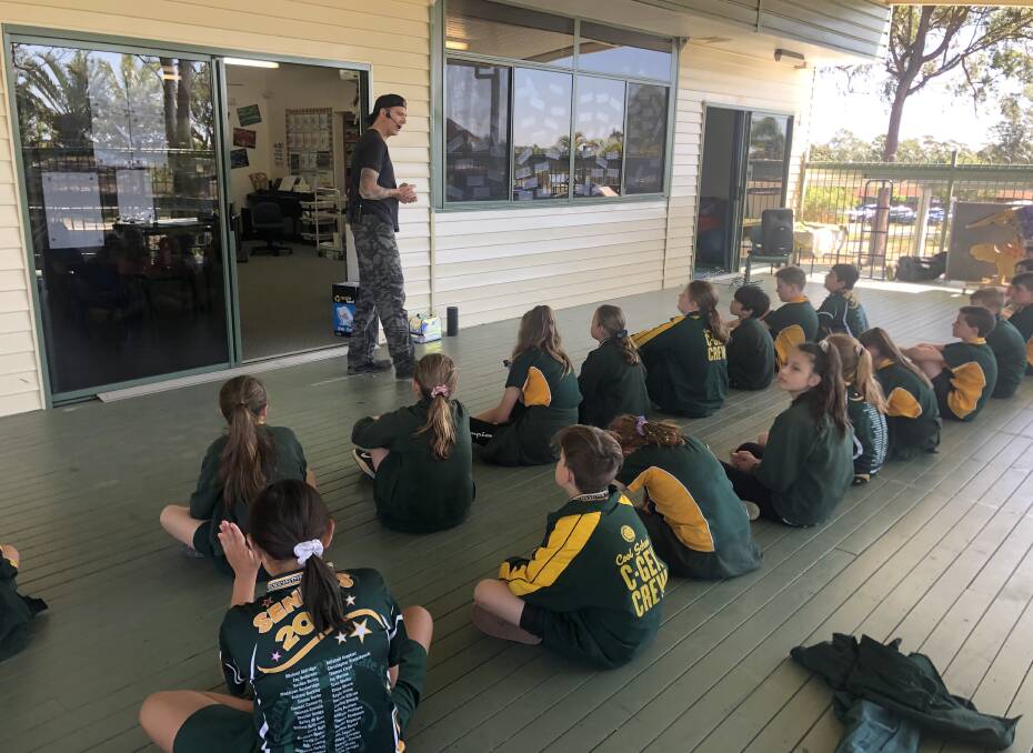 DRUMS: Dr Grant teaches body percussion to year six students at Coolnwynpin State School. 