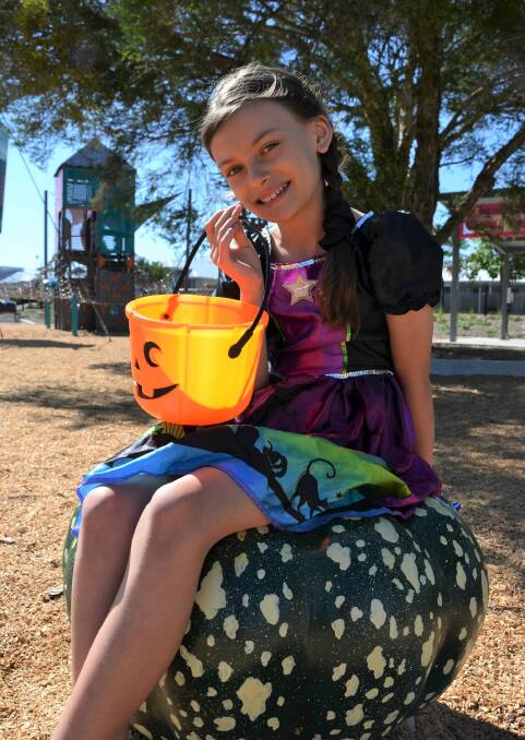 BIG GRIN: Sophie Winter prepares for Haloween celebrations at a local park. 