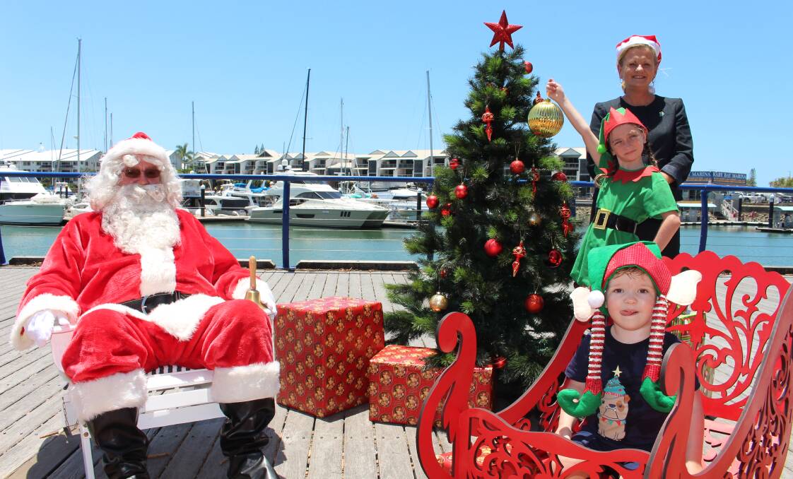 MERRY OLD TIME: Santa Claus joined Mayor Karen Williams, Sophia Ross, 8, of Alexandra Hills and Carter Brown, 2, of Cleveland at Raby Bay Harbour. Photo: Jordan Crick