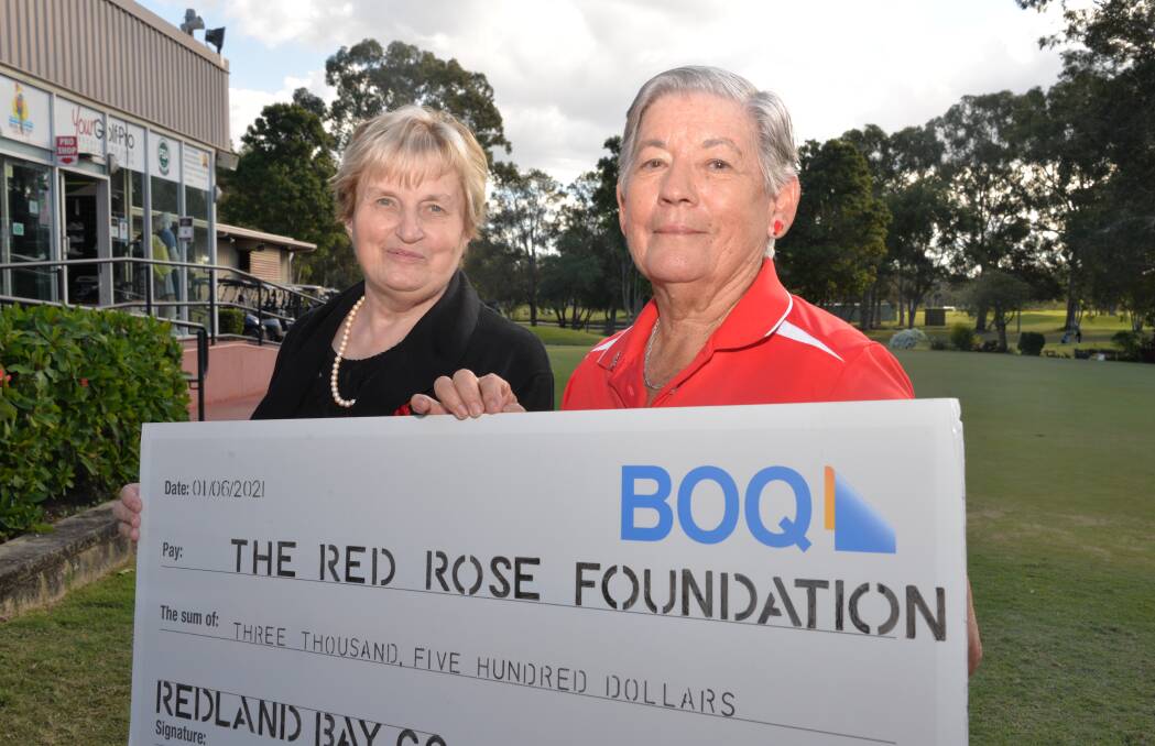 DONATION: Red Rose Foundation chief executive Betty Rose receives a $3500 cheque from Redland Bay Golf Club ladies committee president Michele Stanley. Photo: Jordan Crick